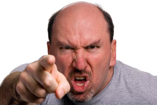 Boze man met gefronste wenkbrauwen – symbool voor woede, frustratie en onbegrip in de nasleep van emotionele schade.