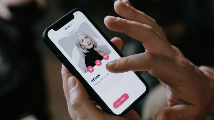 Man swipet door profielen op een dating app.