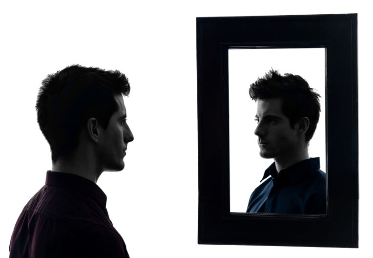 reflectie en zelfinzicht, man die in de spiegel kijkt. terug naar jezelf